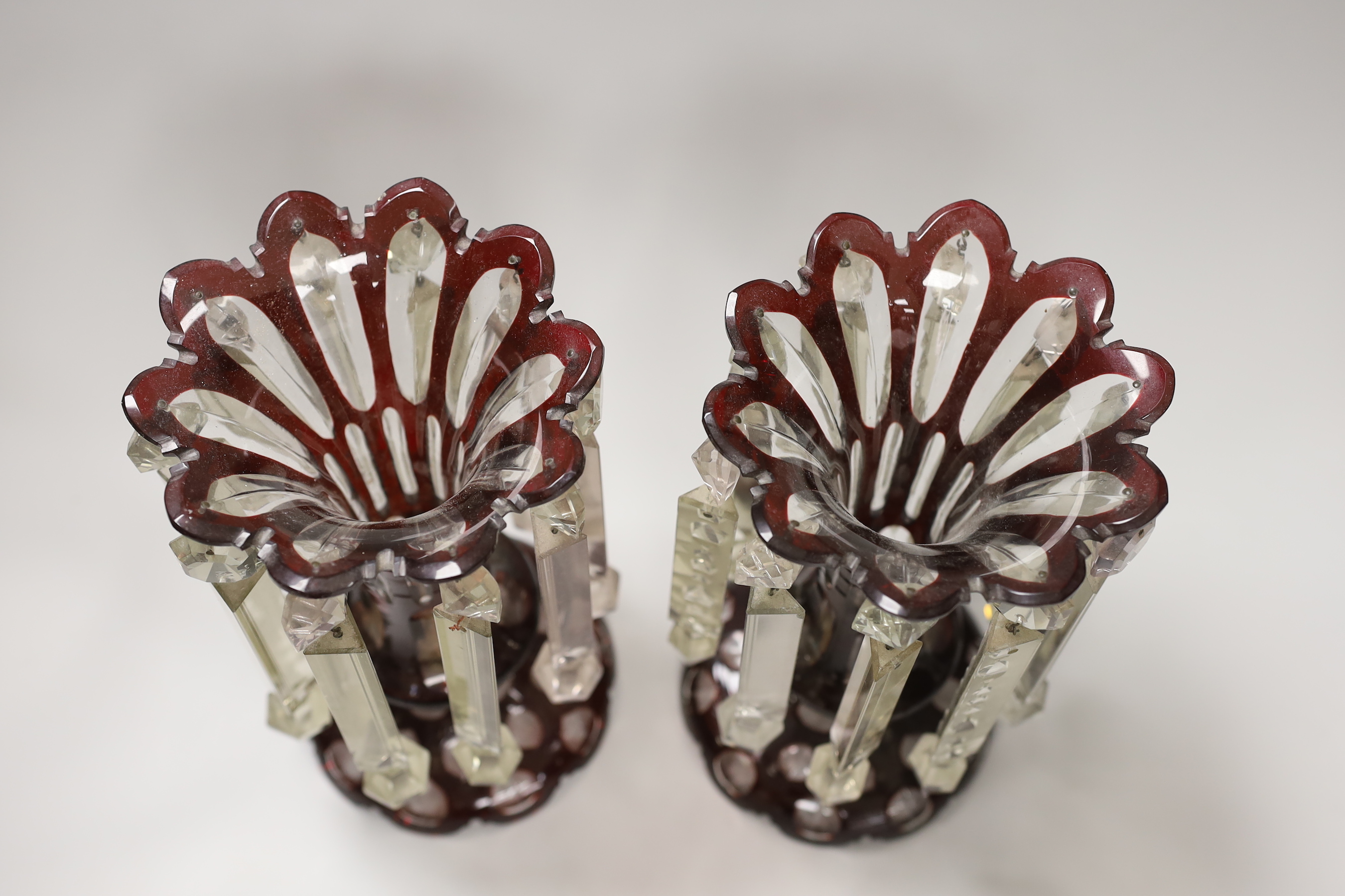 A pair of Victorian ruby overlaid glass table lustres, 28cm